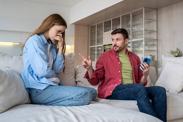 istock Upset woman, serious man quarrel over ambiguous chatting, texting on dating apps, cheating. 2200612811