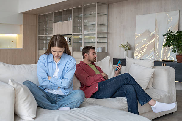 istock Audacious boyfriend communicates with mistress through messenger, overlooks crying, sad girlfriend 2200612823