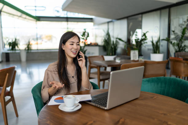 istock Woman working remotely at a cafeteria 2200614156