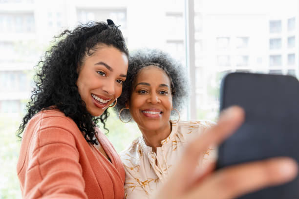 istock Happy Multiracial Mother and Daughter Taking a Selfie 2200614466