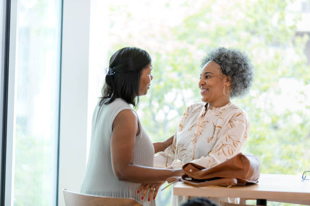 istock Two Happy Women Talking and Bonding Together Indoors 2200614486