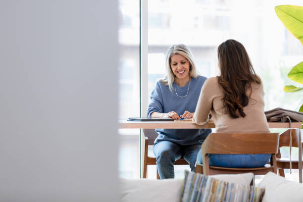 istock Two Women Talking and Working Together in Office 2200614499