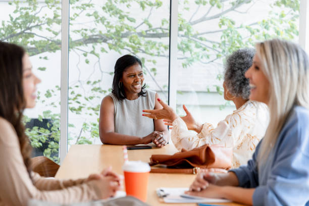 istock Four Women Engaging in Lively Discussion at Office Meeting 2200614531