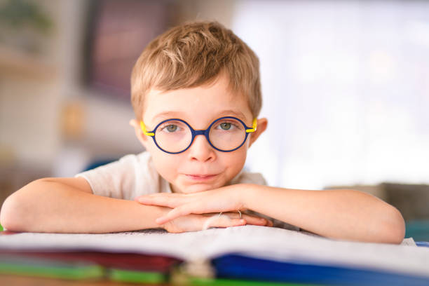 istock homework and school concept - student boy with book writing to notebook at home 2200614724