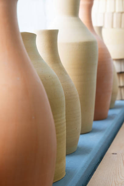 istock Collection of handcrafted earthenware vessels in various sizes and shades 2200616980