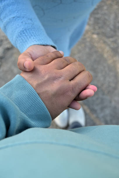 istock Two hands are clasped together in a gesture of connection. 2200618149