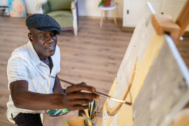 istock Looking down to a senior man painting on canvas 2200620982