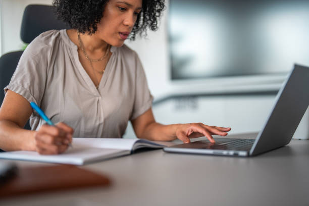 istock Focused Hispanic Businesswoman at Work in Modern Office 2200621095
