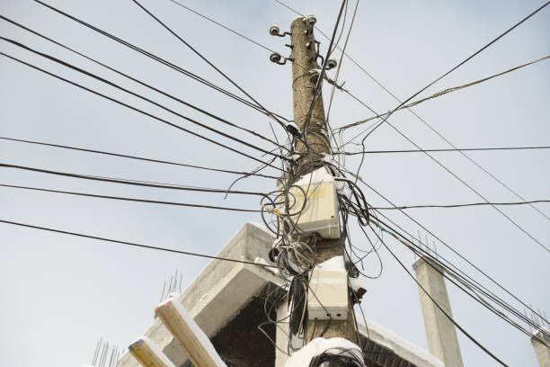 istock Overloaded Utility Pole with Tangled Wires and Electrical Boxes 2200621451