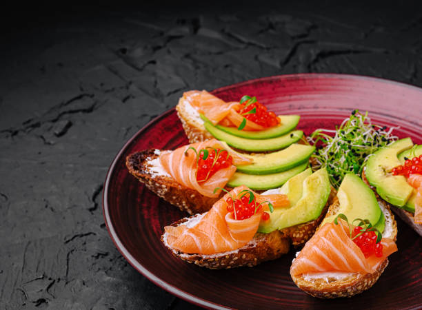 istock Delicious appetizers with salmon, avocado, and caviar served on a decorative plate for a gourmet experience 2200628004