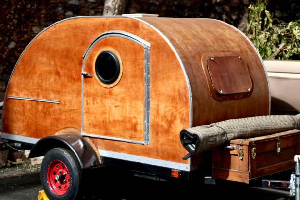 A part, wood panel vintage camper van with warm tones and rich wooden  details