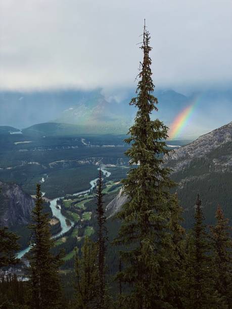 istock Rainbow over misty mountains and a winding river in Banff National Park 2200631128