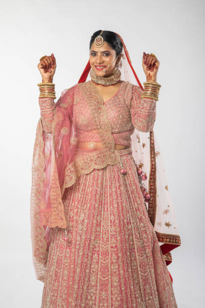 istock Happy bride in traditional clothing dancing over white background 2200632126