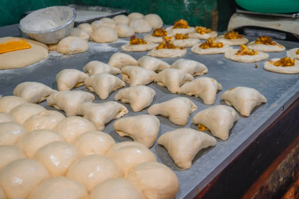 istock Image of raw dough, ready to bake / savory vegetable buns with potato, onion / flour paste for fried / cooked bakery 2200632906