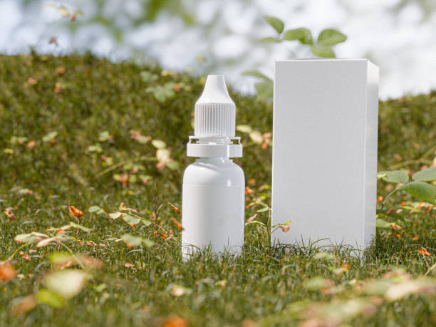A sleek dropper bottle with a white cap and matching box, photographed in a lush outdoor environment to highlight natural skincare concepts.