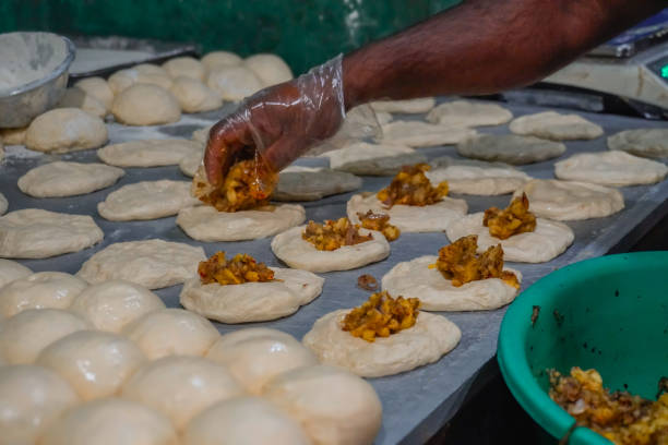 istock Image of baker's hand placing savory paste on raw dough / flour, potato, onion, vegetable bun, ready to bake 2200633895