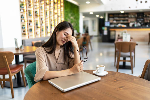 istock Tired businesswoman covered her face with her hands 2200633899