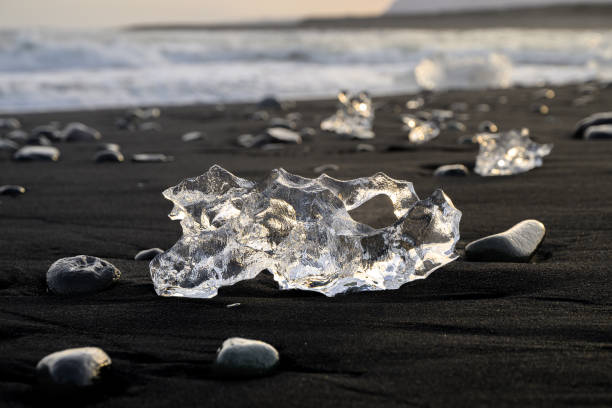 Clear ice on black sand beach near Jökulsárlón Glacier Lagoon.