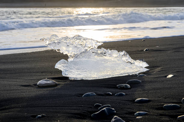 Clear ice on black sand beach near Jökulsárlón Glacier Lagoon.