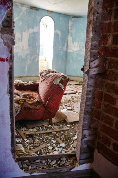 istock Abandoned Red Armchair in Decayed Room with Arched Window Forgotten Interior View 2200635029