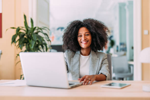 istock Successful businesswoman in modern office working on laptop. 2200635453