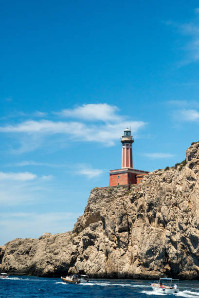 istock Capri island lighthouse on Rocky Cliff 2200635647