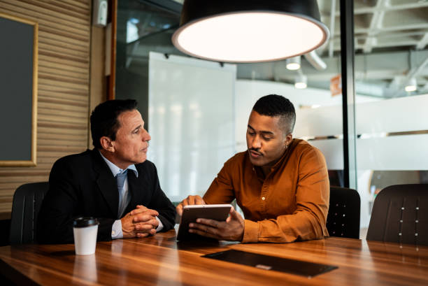 istock Businessman showing the digital tablet to boss on the office 2200636302