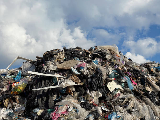 istock Large pile of refuse dominates the landscape, with various materials visible against a backdrop of dramatic clouds, highlighting pollution challenges 2200638281