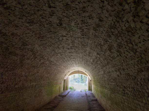 istock Tunnel lined with red bricks in the old fortress 2200638759