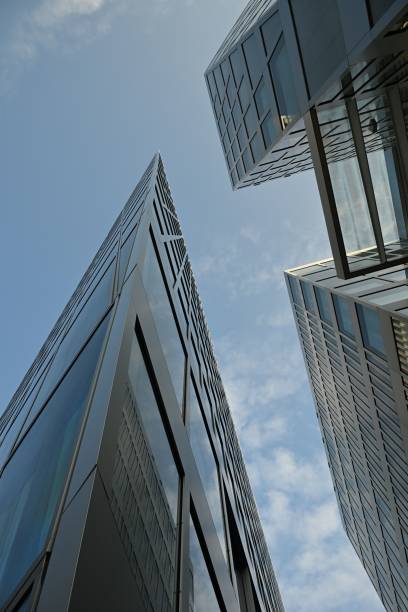 istock Modern skyscrapers with reflective glass facades against a blue sky. 2200638773