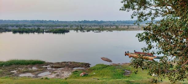 Halebeedu, Karnataka, India - January 2023: People fishing on the banks of the Dwarasamudra lake in the tourist village of Halibedu near Hassan.