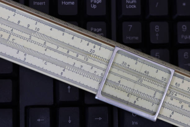 A fragment of a slide rule on a black computer keyboard