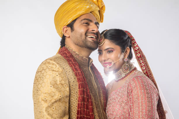 istock Bride and groom embracing and posing on white background 2200641382