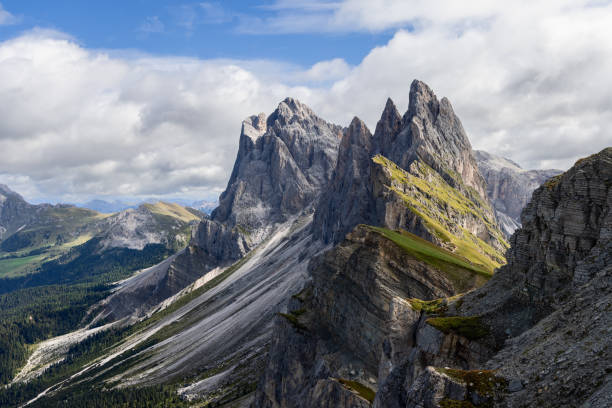 istock Seceda iconic jagged ridges stretch above sheer cliffs and a green plateau, blending rugged textures with serene valleys under shifting clouds 2200642391