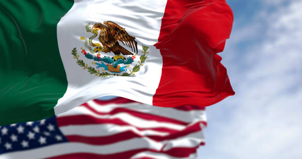 istock Mexico and US national flags waving on a clear day 2200643481