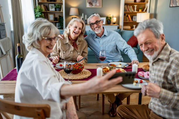istock Senior friends taking selfies during lunch 2200646433