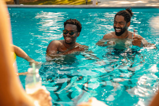 istock Joyful male friends in the pool 2200650871