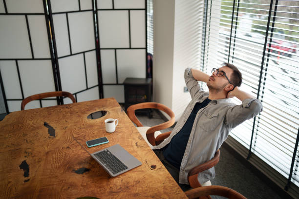istock Businessman with his hands behind his head at the office. 2200651277