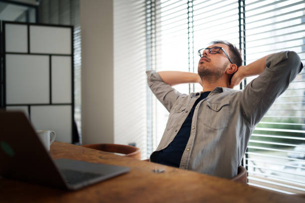 istock Businessman with his hands behind his head at the office. 2200651363