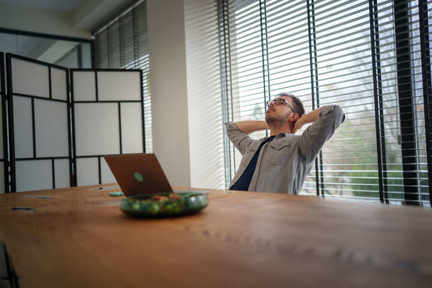 istock Businessman with his hands behind his head at the office. 2200651365