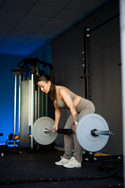istock Happy female athlete having strength training in a gym. 2200654235
