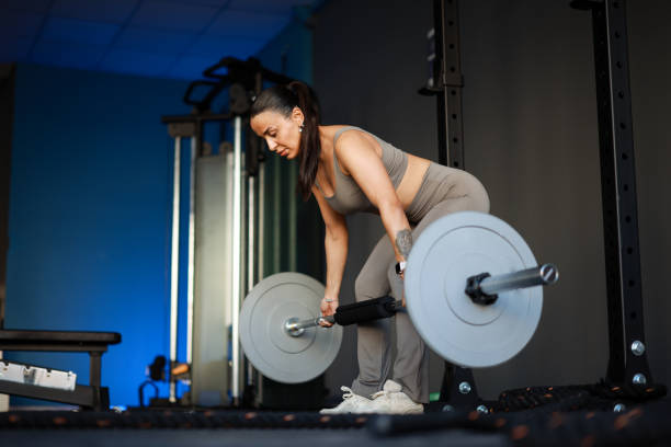 istock Happy female athlete having strength training in a gym. 2200654415