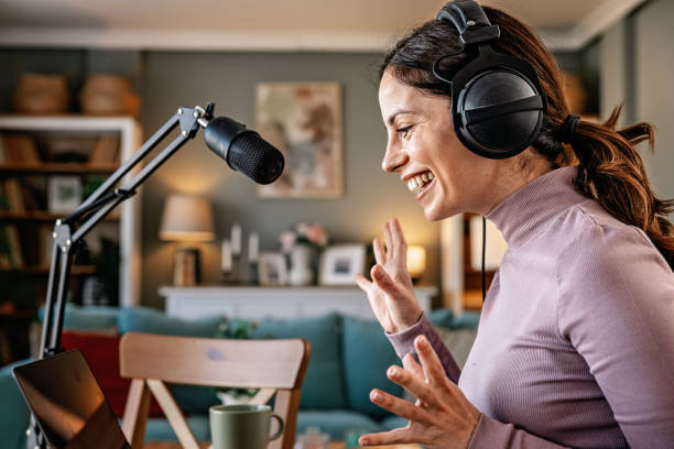 istock Joyful woman recording live podcast 2200655626