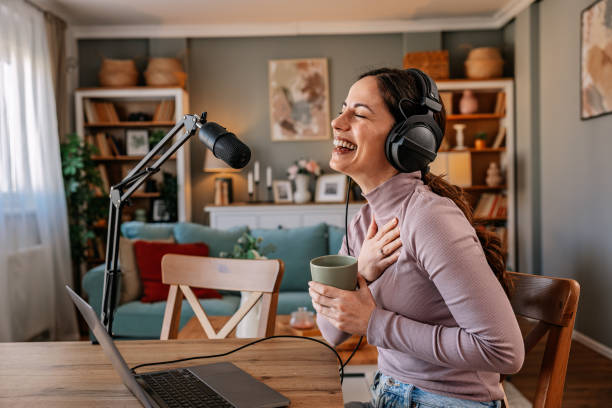 istock Joyful woman recording live podcast 2200655740