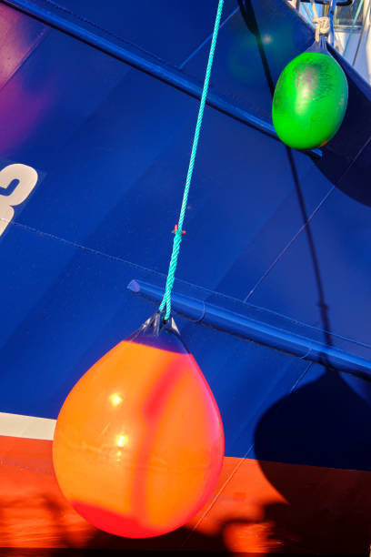 istock Vibrant buoys hanging from a blue boat 2200655765