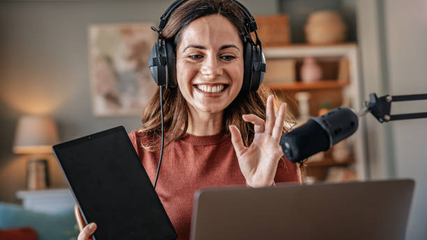 istock Joyful woman recording live podcast 2200656677