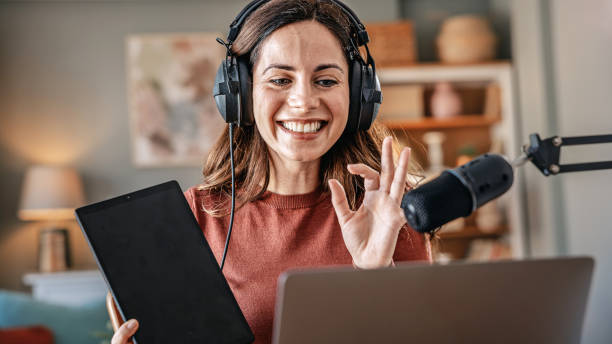 istock Joyful woman recording live podcast 2200656695
