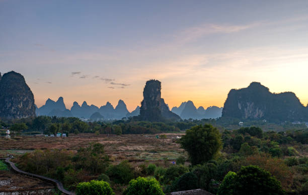 istock Vibrant Sunrise Over the Breathtakingly Beautiful Scenery and Dramatic Limestone Rock Formations of the Yulonghe Scenic Area of Yangshuo County, Guilin, Guangxi China 2200658008