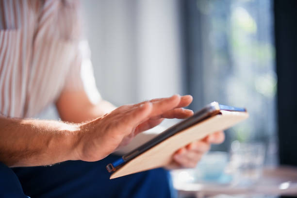 istock Close-Up of Hand Interacting with Digital Tablet in Bright Room 2200660405