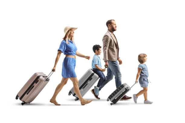 istock Family with children walking and pulling suitcases 2200660649